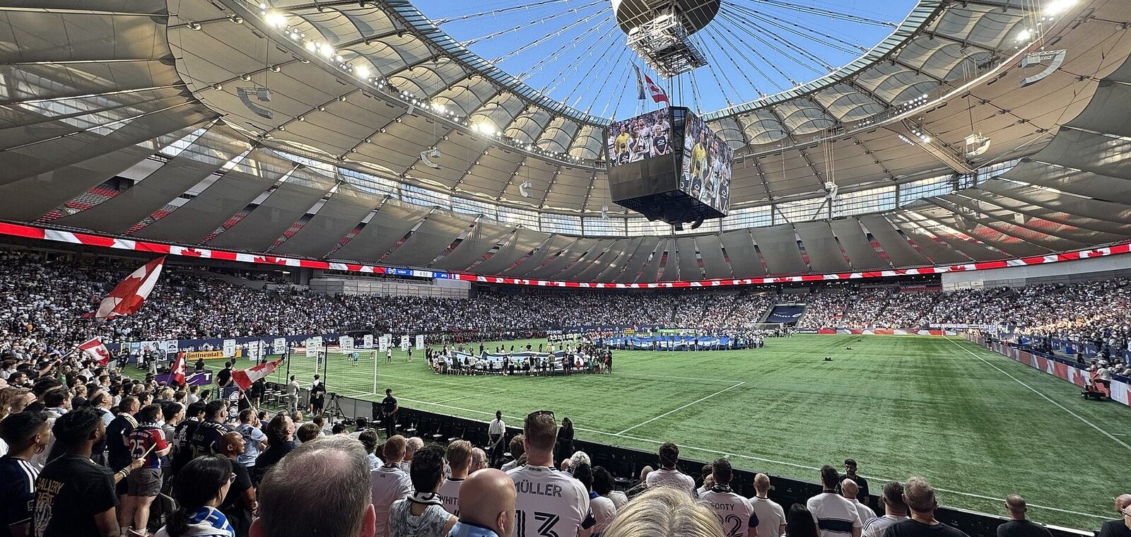 Whitecaps crowd at BC Place with the retractable roof open to a blue sky above the pitch