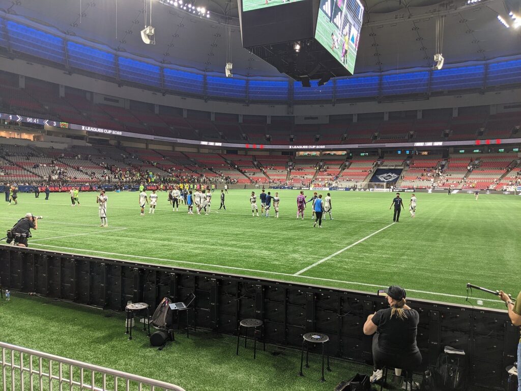 Whitecaps players on the BC Place pitch after a 2026 Leagues Cup match, seen from pitch level