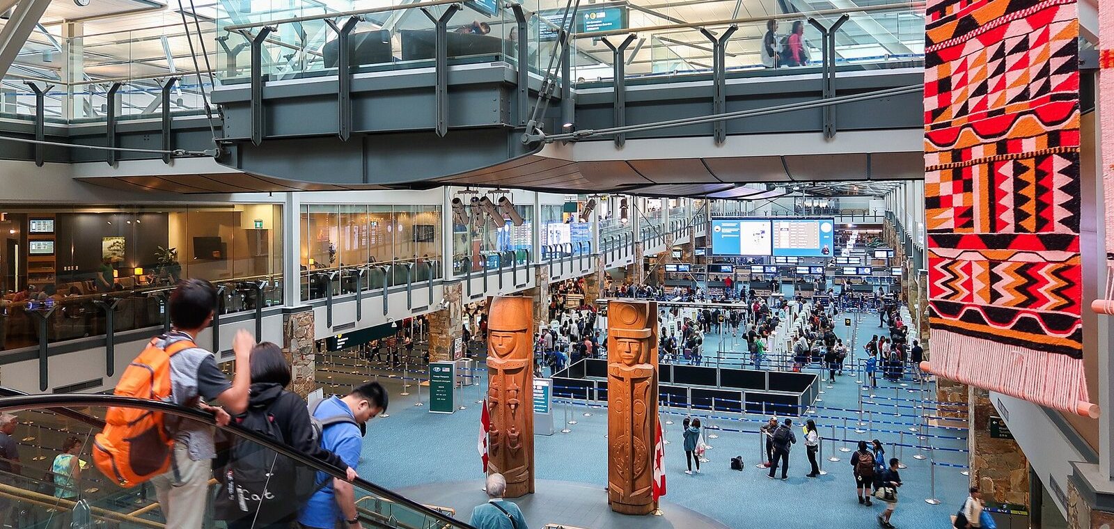 Travellers in the international arrivals hall at Vancouver International Airport after meeting the eTA Canada requirements